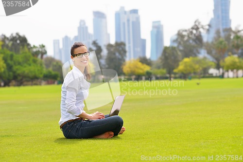 Image of woman with laptop in park