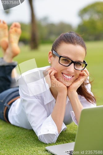 Image of woman with laptop in park