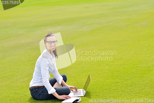 Image of woman with laptop in park