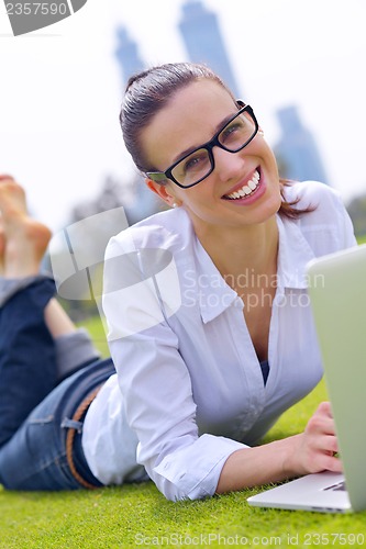Image of woman with laptop in park