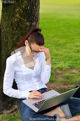 Image of woman with laptop in park