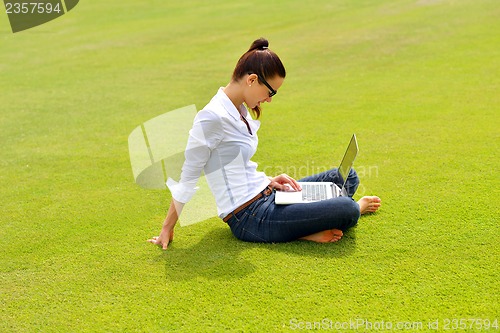 Image of woman with laptop in park