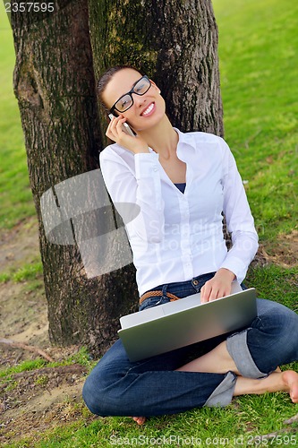 Image of woman with laptop in park