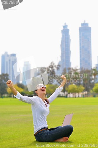 Image of woman with laptop in park