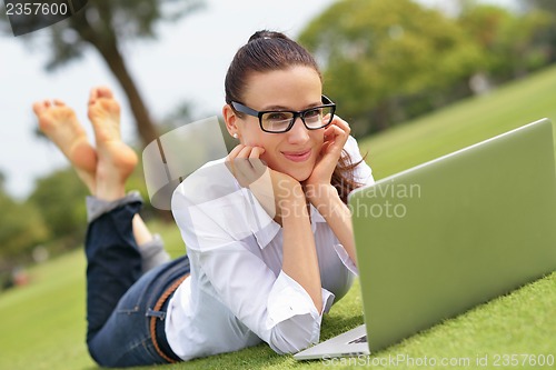 Image of woman with laptop in park