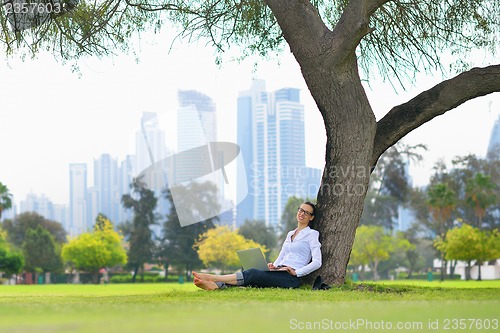 Image of woman with laptop in park