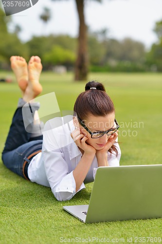 Image of woman with laptop in park