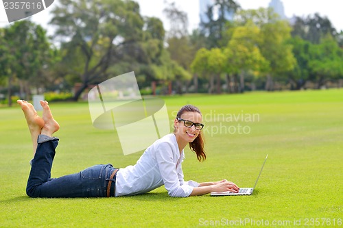 Image of woman with laptop in park