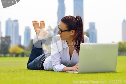 Image of woman with laptop in park