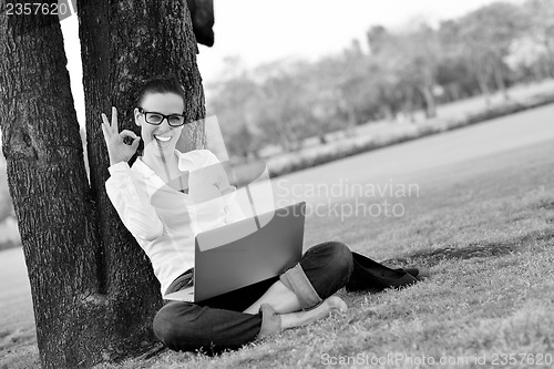 Image of woman with laptop in park