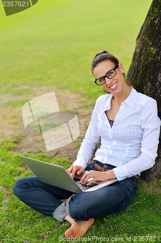 Image of woman with laptop in park