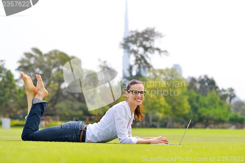 Image of woman with laptop in park
