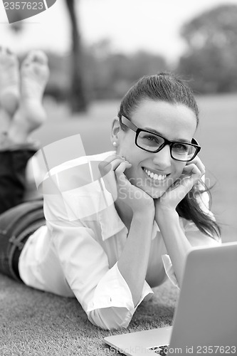 Image of woman with laptop in park