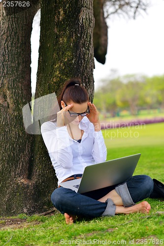 Image of woman with laptop in park