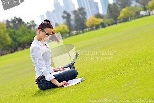 Image of woman with laptop in park