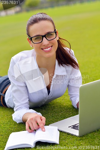 Image of woman with laptop in park