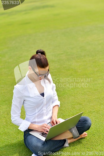 Image of woman with laptop in park