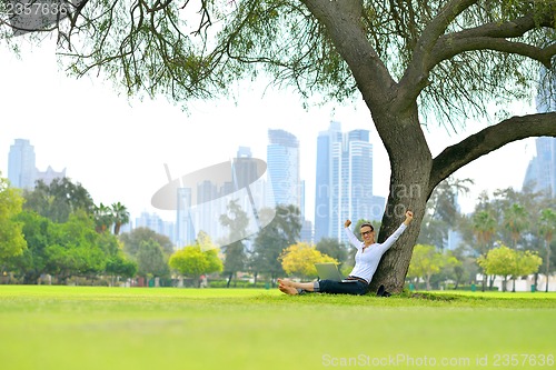 Image of woman with laptop in park