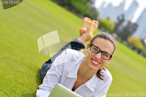 Image of woman with laptop in park