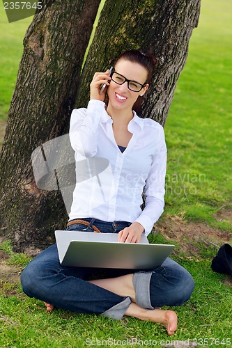 Image of woman with laptop in park