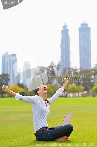 Image of woman with laptop in park