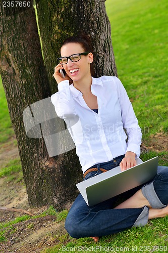 Image of woman with laptop in park