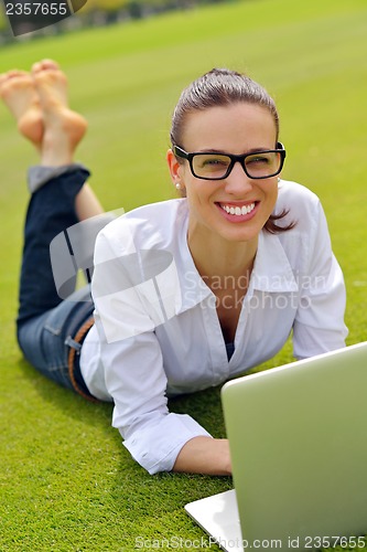 Image of woman with laptop in park