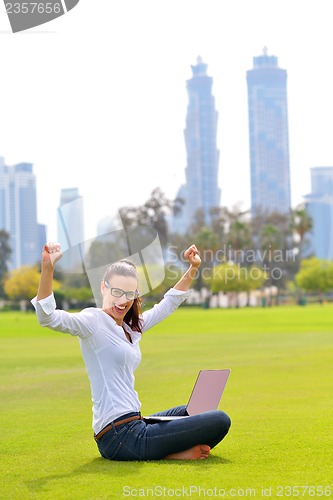 Image of woman with laptop in park