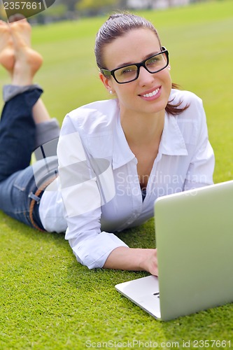 Image of woman with laptop in park