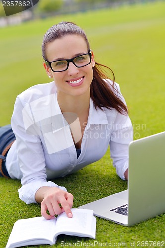 Image of woman with laptop in park