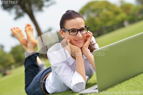 Image of woman with laptop in park