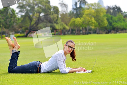 Image of woman with laptop in park