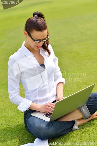 Image of woman with laptop in park