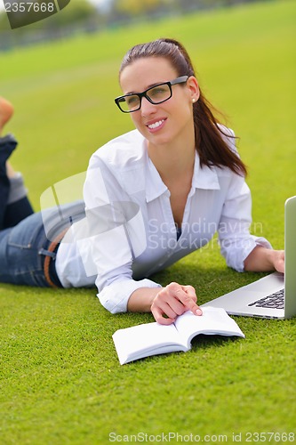 Image of woman with laptop in park