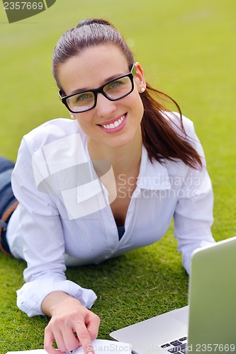 Image of woman with laptop in park