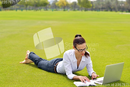 Image of woman with laptop in park