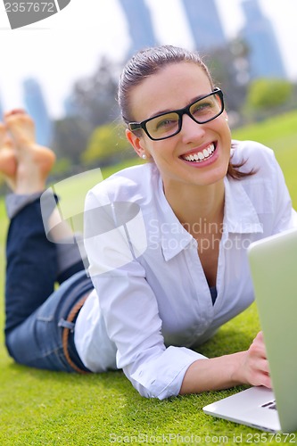 Image of woman with laptop in park