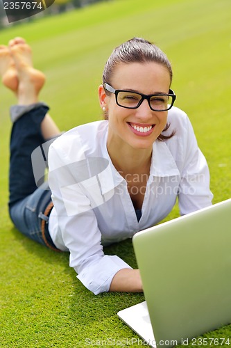 Image of woman with laptop in park