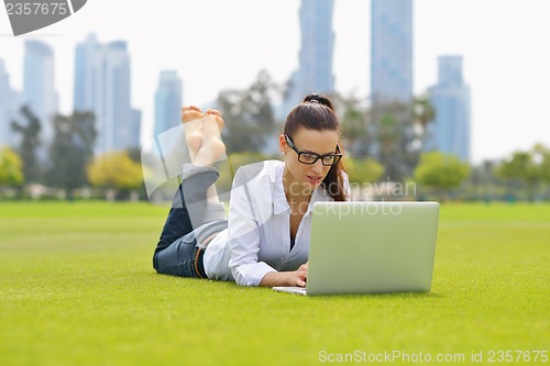 Image of woman with laptop in park