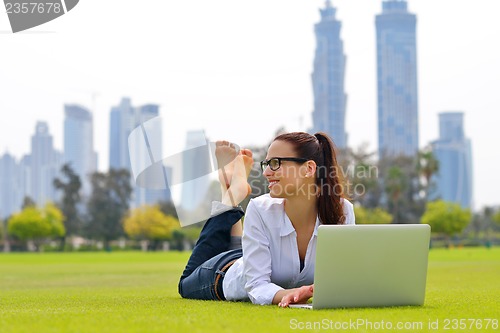 Image of woman with laptop in park