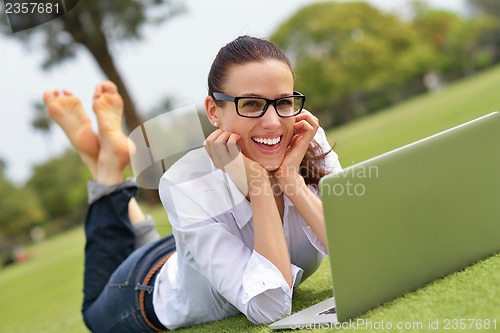 Image of woman with laptop in park