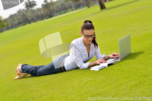 Image of woman with laptop in park