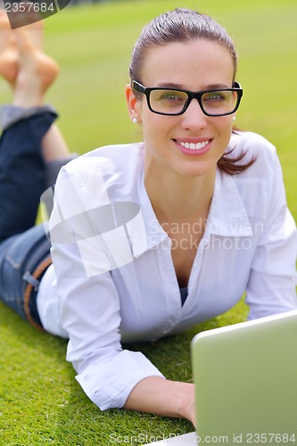 Image of woman with laptop in park