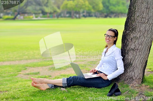 Image of woman with laptop in park
