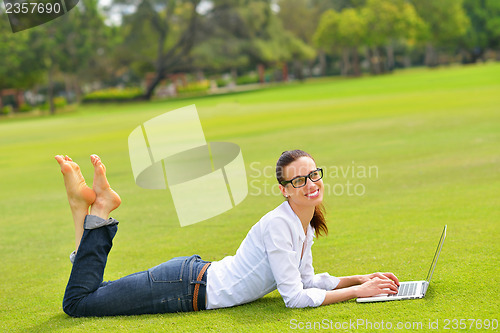 Image of woman with laptop in park