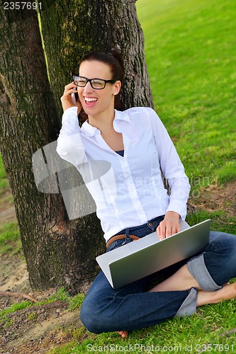 Image of woman with laptop in park