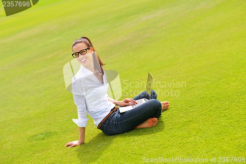 Image of woman with laptop in park