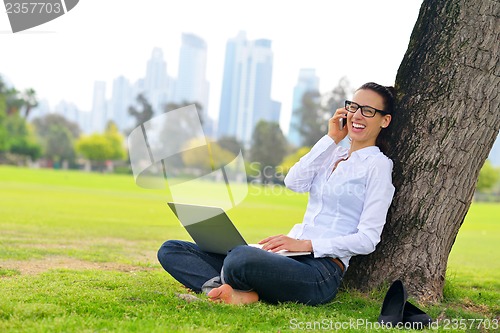 Image of woman with laptop in park