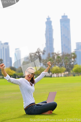 Image of woman with laptop in park