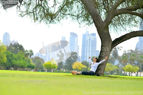 Image of woman with laptop in park